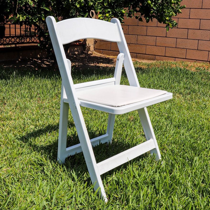 white resin padded folding chair